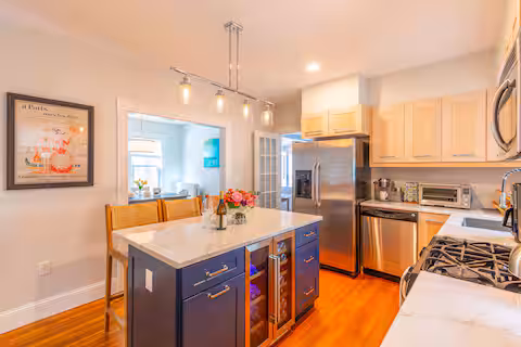 Kitchen with wine fridge and stainless appliances
